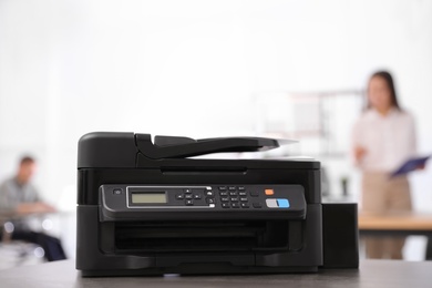 New modern printer on table in office