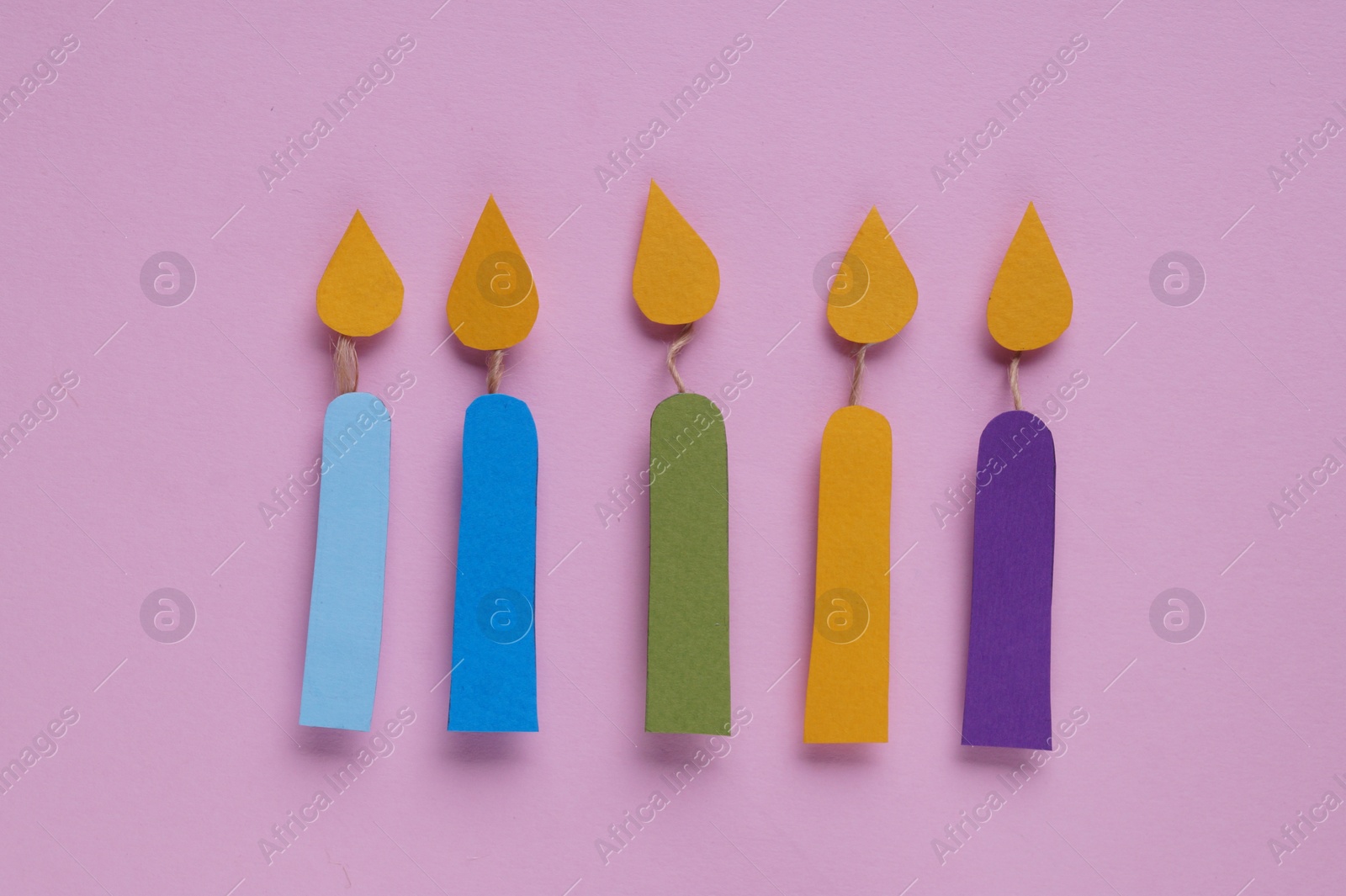 Photo of Different paper candles on pink background, flat lay