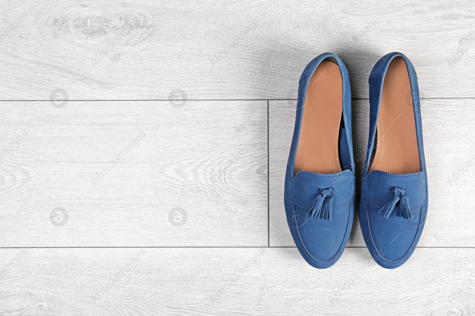 Photo of Pair of female shoes on wooden background, top view