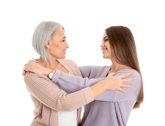 Portrait of young woman with her mature mother on white background