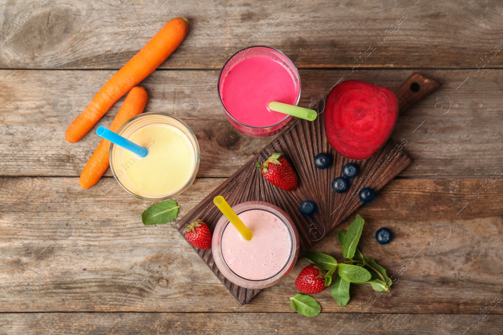 Photo of Flat lay composition with healthy detox smoothies and ingredients on wooden background