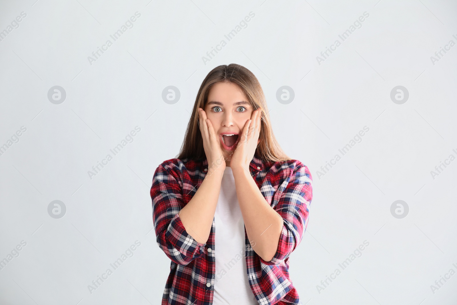 Photo of Portrait of surprised young woman on white background