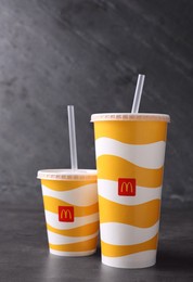 MYKOLAIV, UKRAINE - AUGUST 12, 2021: Cold McDonald's drinks on grey table
