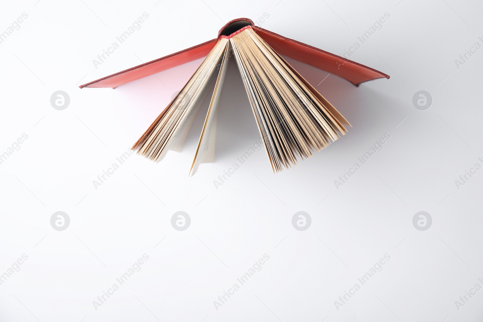 Photo of Open book on white background, top view