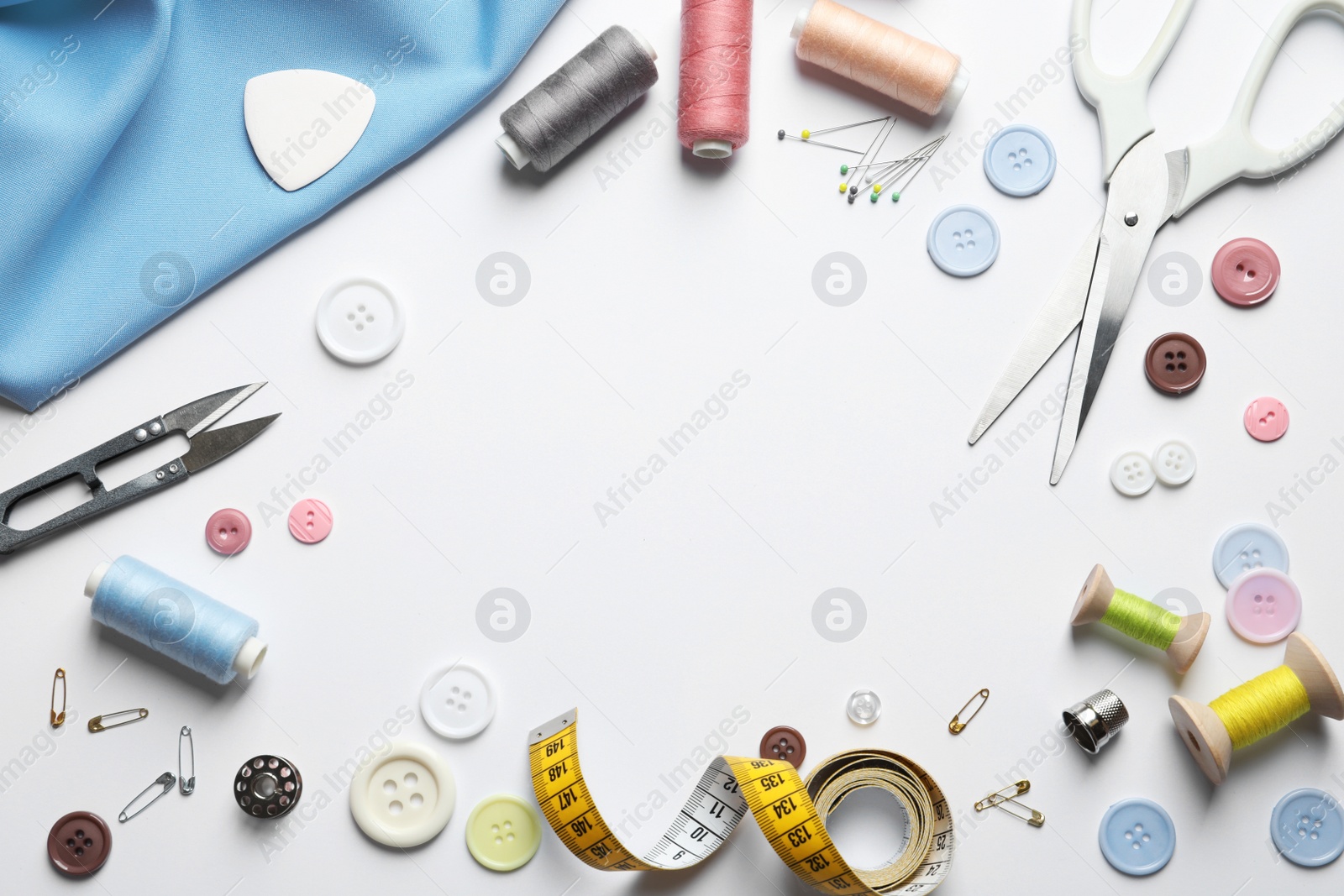 Photo of Flat lay composition with scissors and sewing supplies on white background. Space for text
