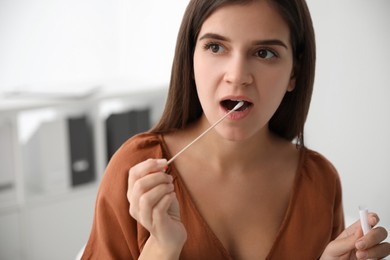 Photo of Woman taking sample for DNA test indoors