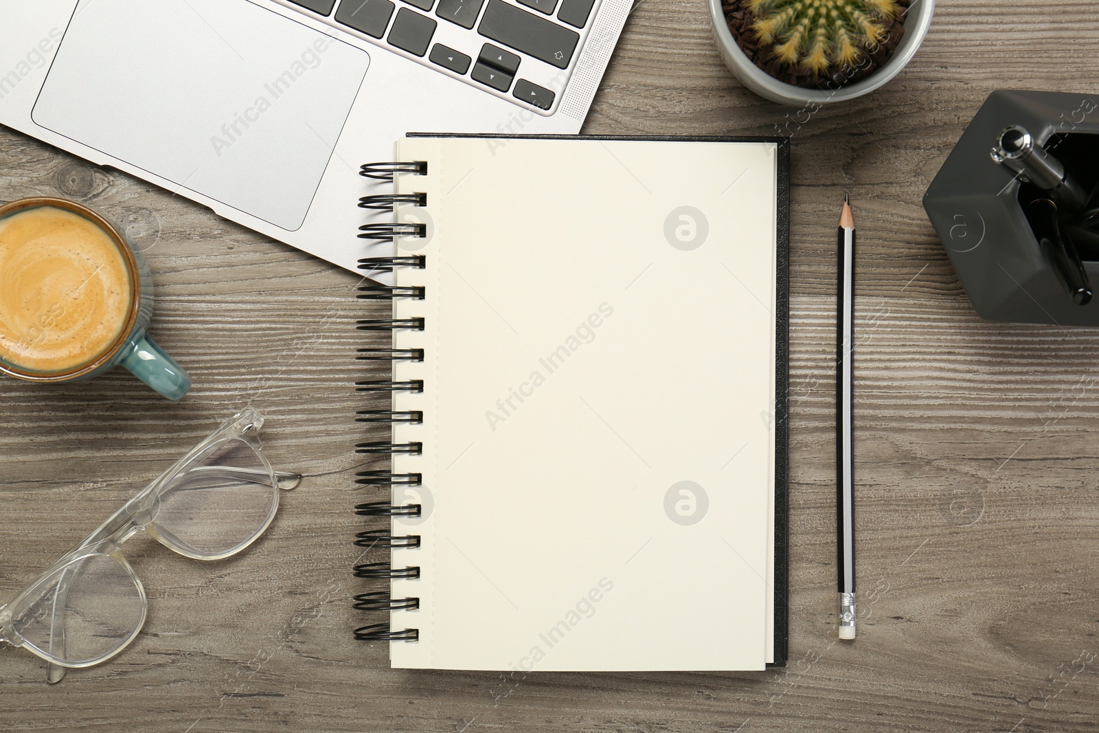 Photo of Flat lay composition with notebook and laptop on wooden table