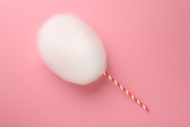 Photo of One sweet cotton candy on pink background, top view