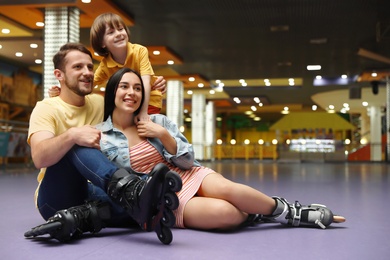 Happy family spending time at roller skating rink