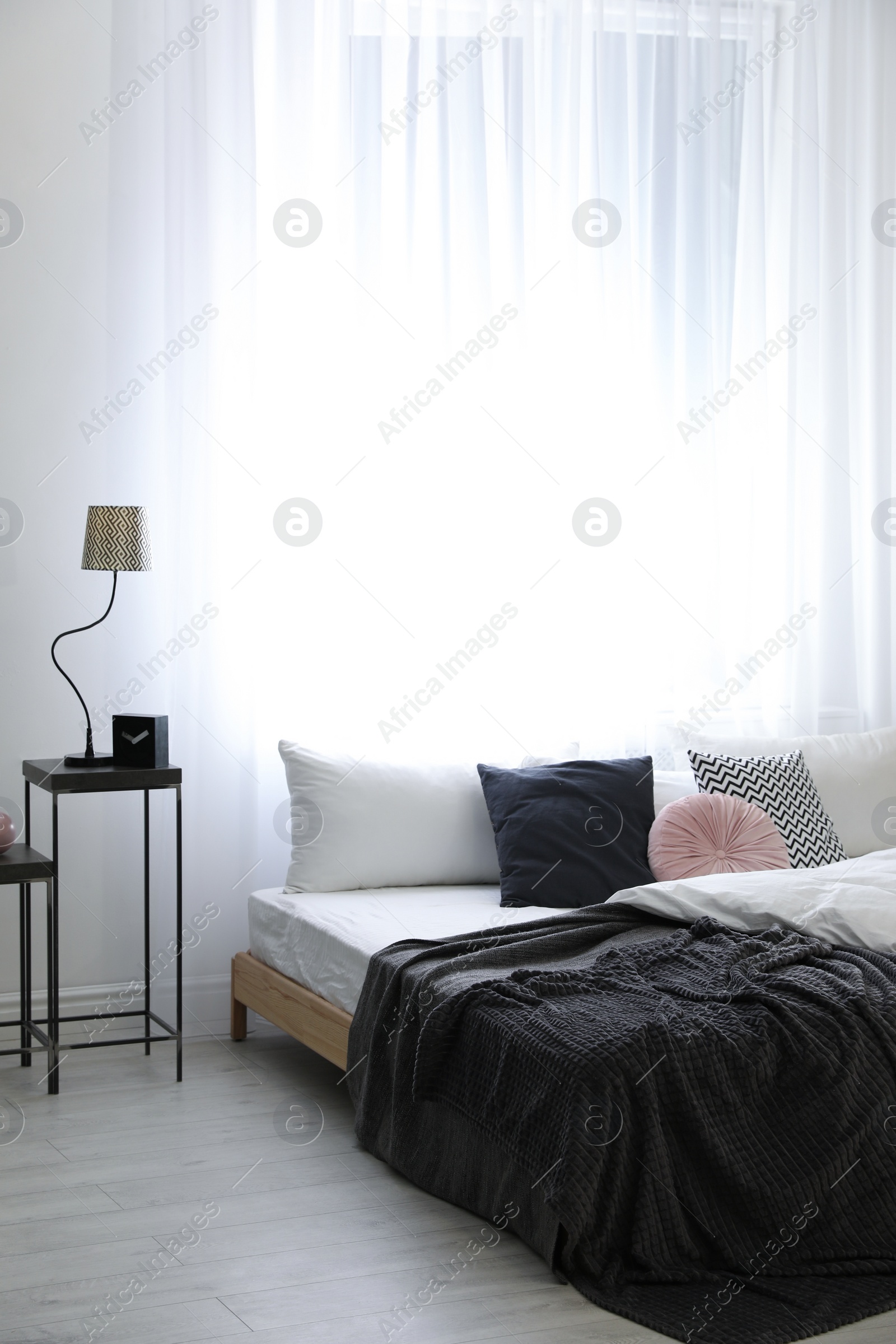 Photo of Stylish room interior with big comfortable bed