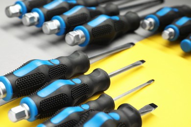 Set of screwdrivers on color background, closeup