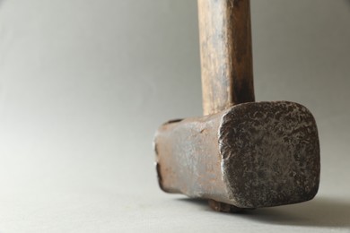 Photo of One sledgehammer on grey background, closeup. Space for text