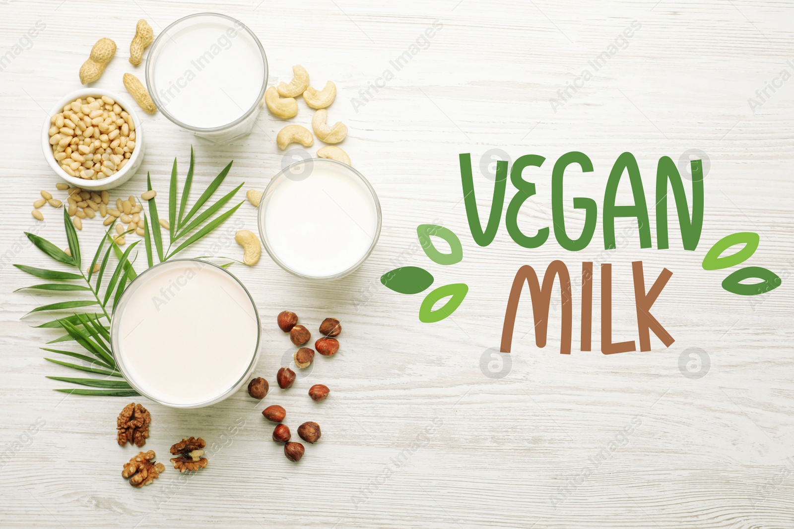 Image of Different vegan milks and nuts on white wooden table, flat lay