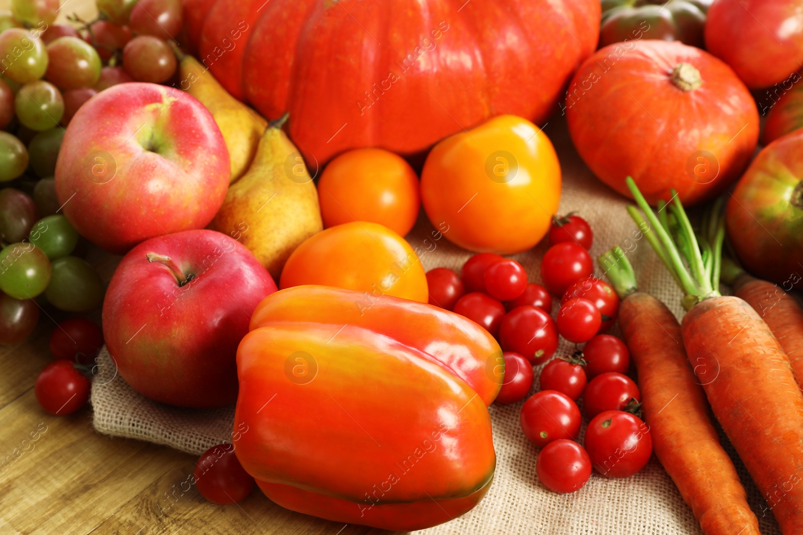 Photo of Different fresh ripe vegetables and fruits on wooden table, closeup