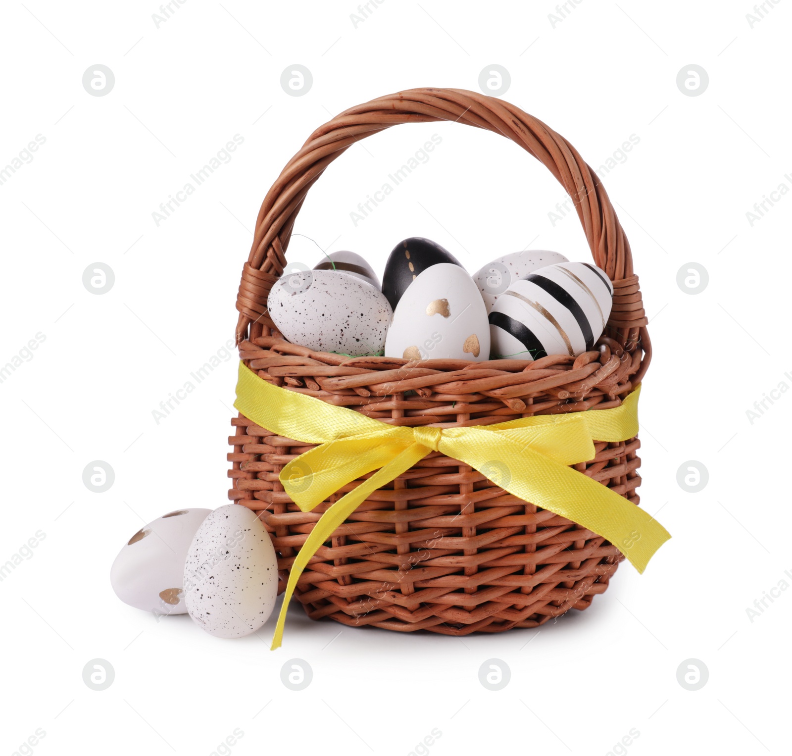 Photo of Wicker basket with beautifully painted Easter eggs isolated on white