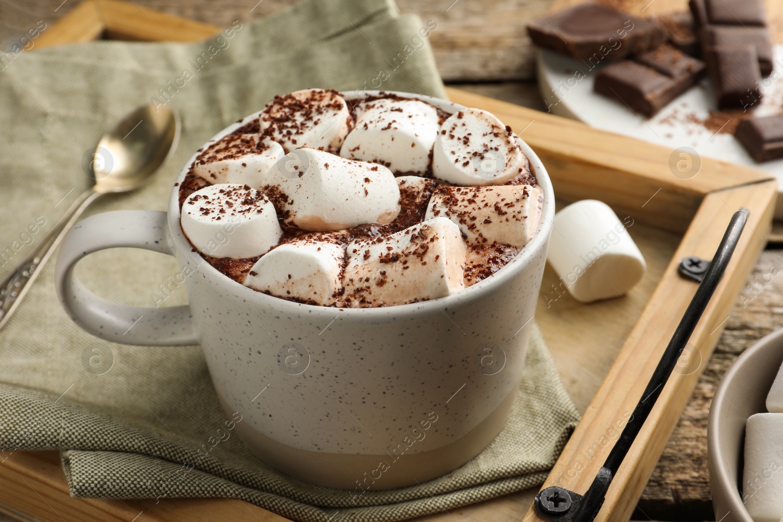 Photo of Delicious hot chocolate with marshmallows and cocoa powder on table, closeup