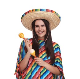 Young woman in Mexican sombrero hat and poncho with maracas on white background