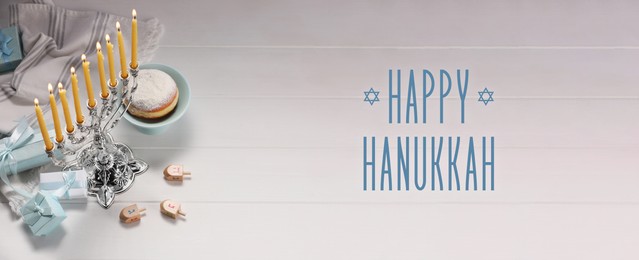 Image of Happy Hanukkah. Menorah, donut, dreidels and gifts on white wooden table, banner design