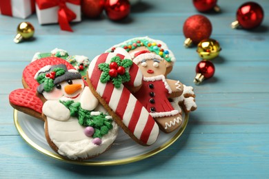 Photo of Sweet Christmas cookies and decor on light blue wooden table