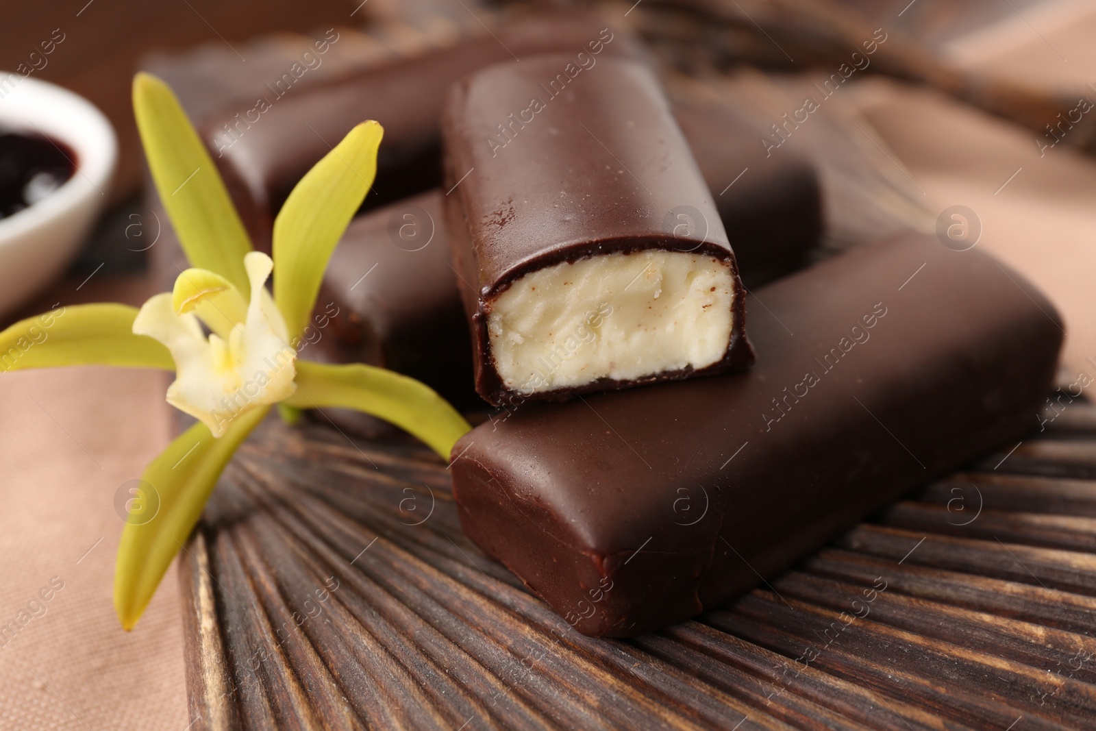 Photo of Glazed vanilla curd cheese bars served on table, closeup