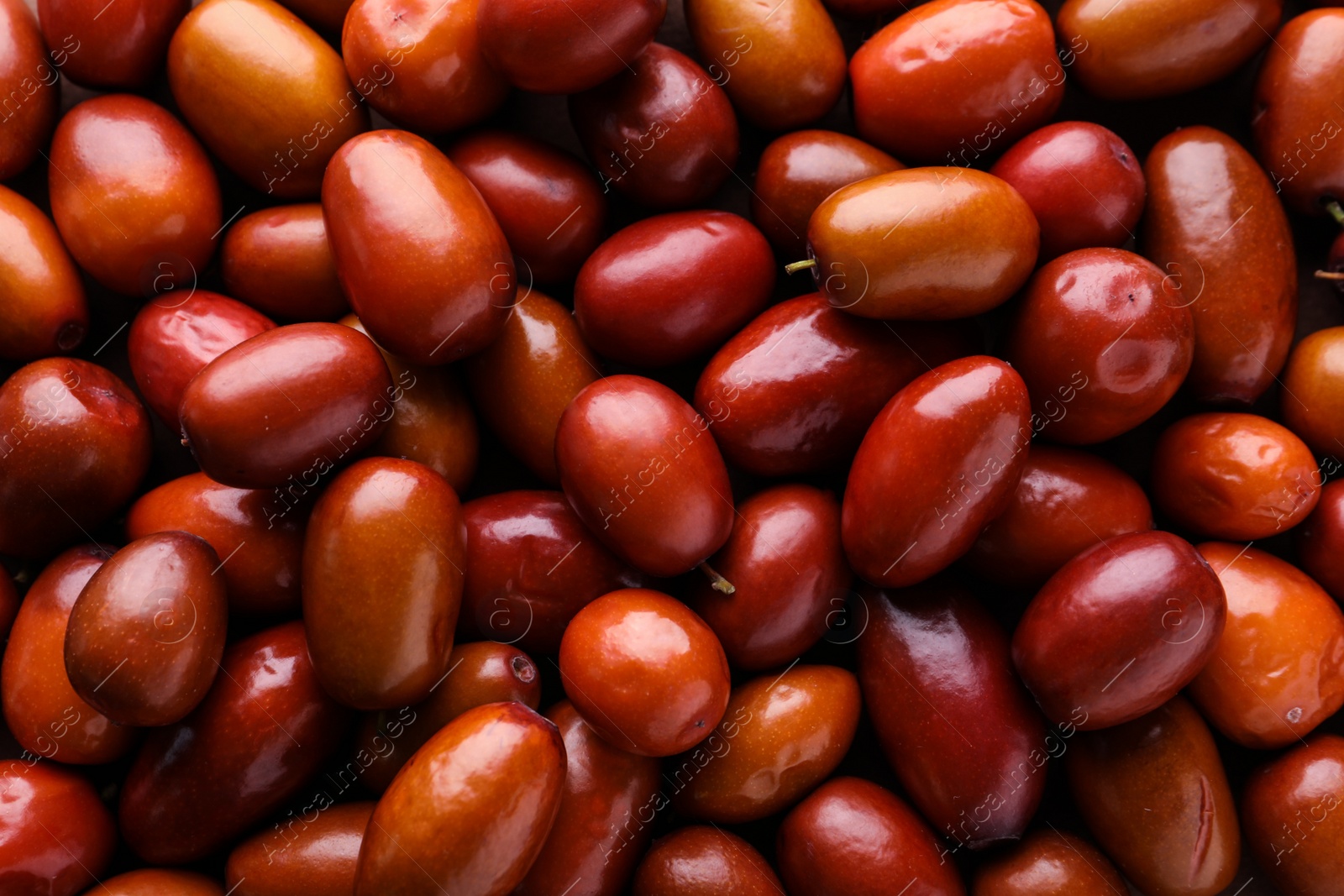 Photo of Heap of ripe red dates as background, closeup