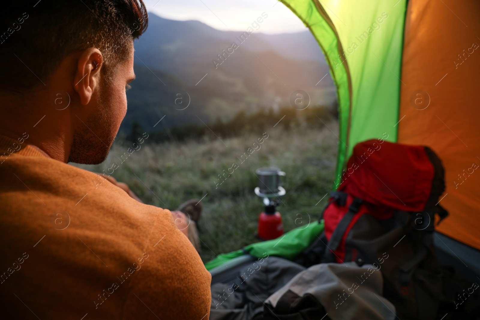 Photo of Man inside of camping tent in mountains