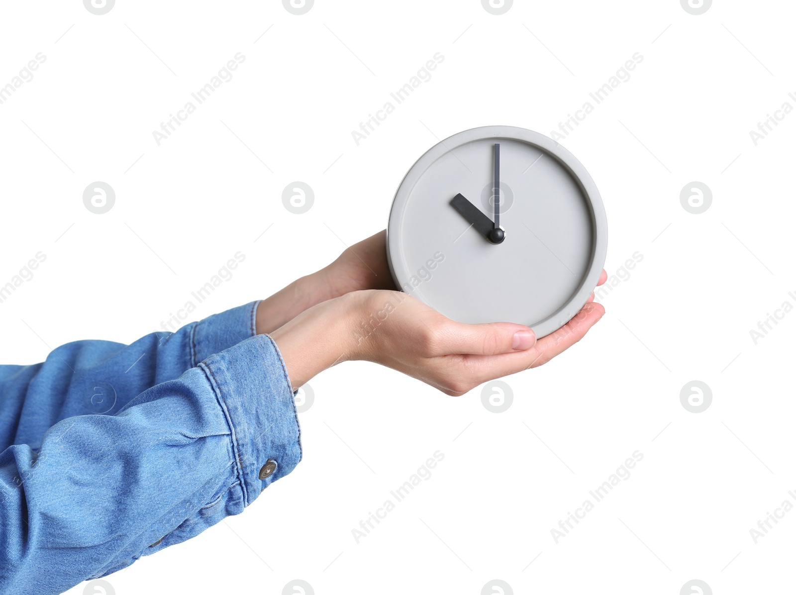 Photo of Young woman holding alarm clock on white background. Time concept