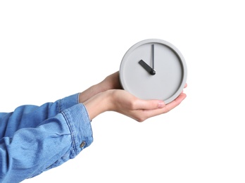 Photo of Young woman holding alarm clock on white background. Time concept