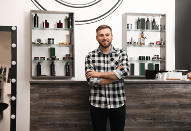 Photo of Young business owner in his barber shop