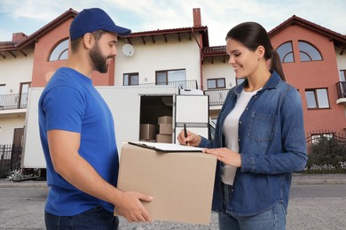 Image of Courier delivery. Woman signing order receipt outdoors