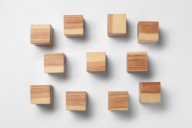 Photo of Blank wooden cubes on white background, flat lay