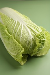 Photo of Fresh ripe Chinese cabbage on pale green background, closeup