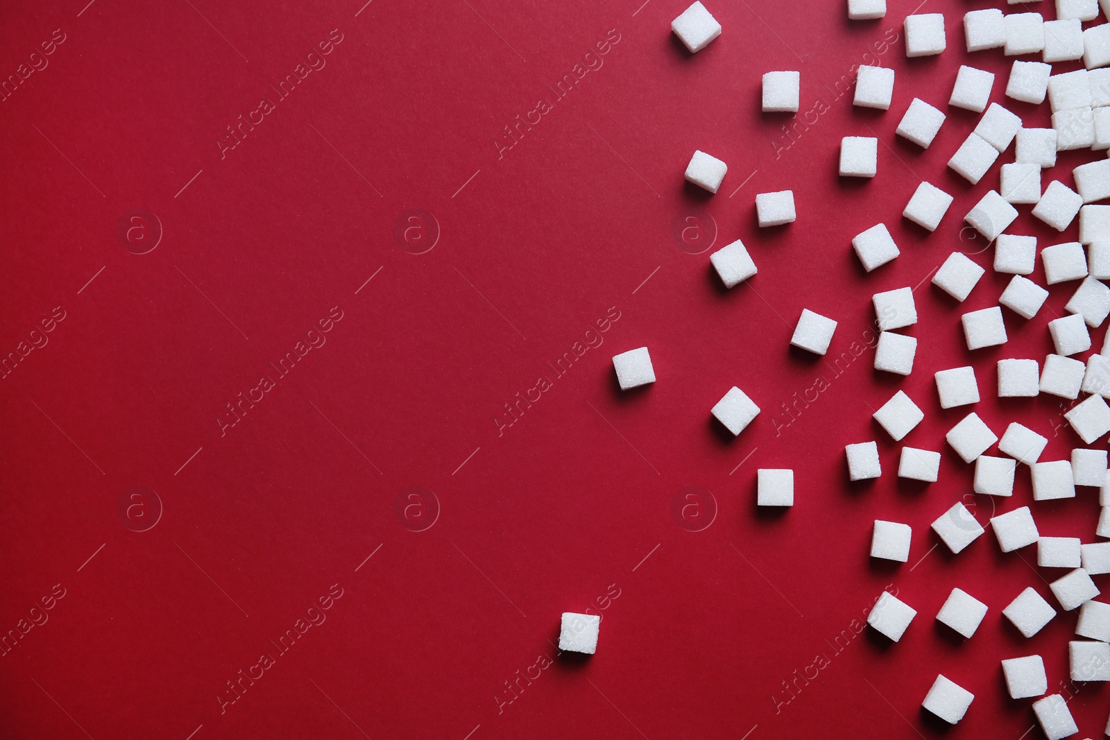 Photo of Refined sugar cubes on color background, top view