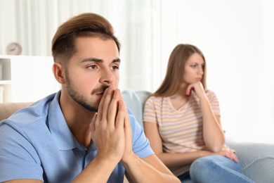 Photo of Young couple with relationship problems in living room