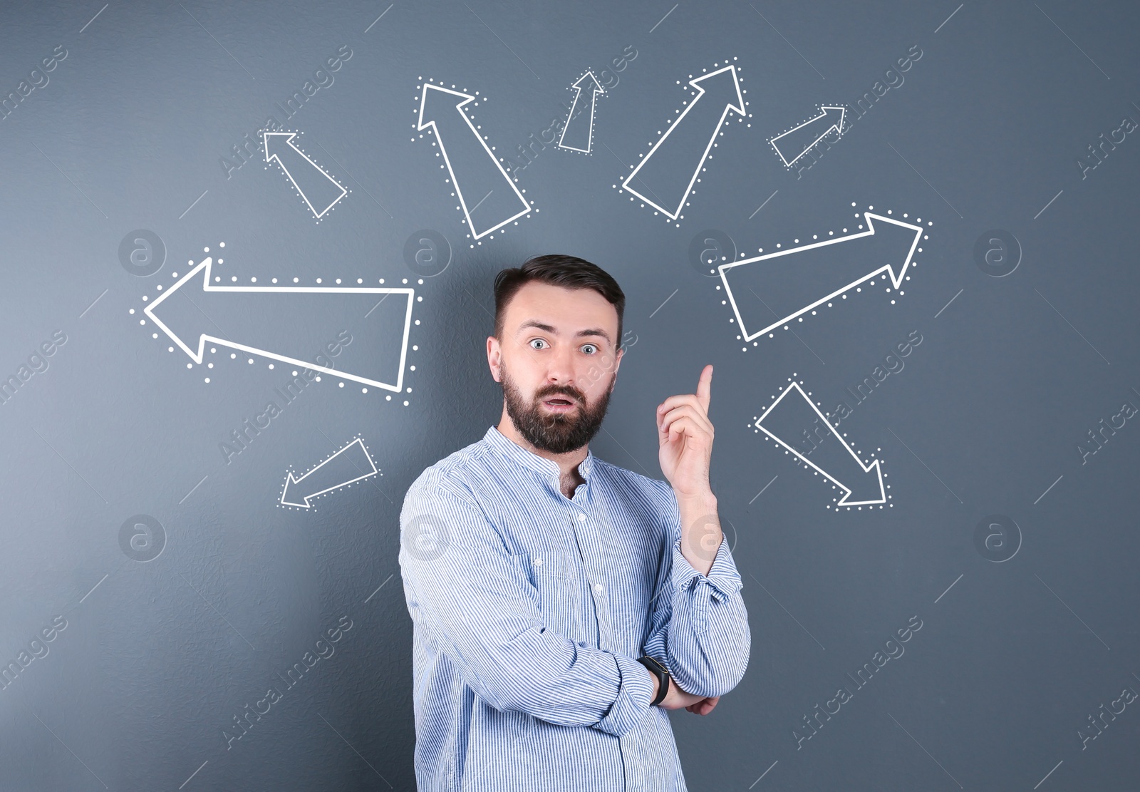 Image of Choice in profession or other areas of life, concept. Making decision, emotional man surrounded by drawn arrows on grey background