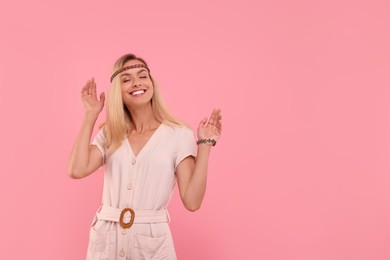Photo of Portrait of happy hippie woman on pink background. Space for text