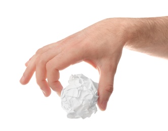 Photo of Man crumpling paper against white background, closeup. Generating idea