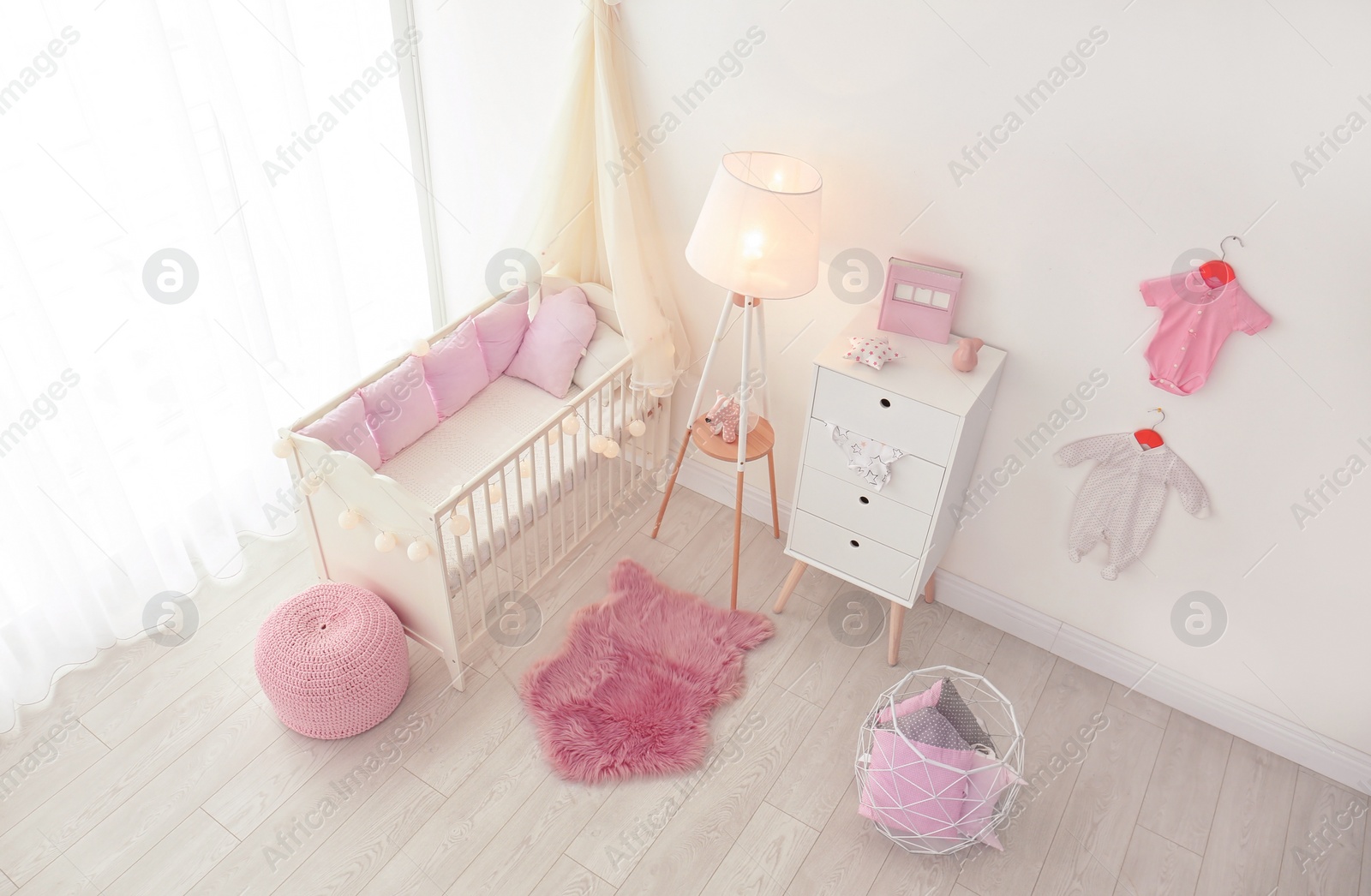 Photo of Interior of baby room with comfortable crib