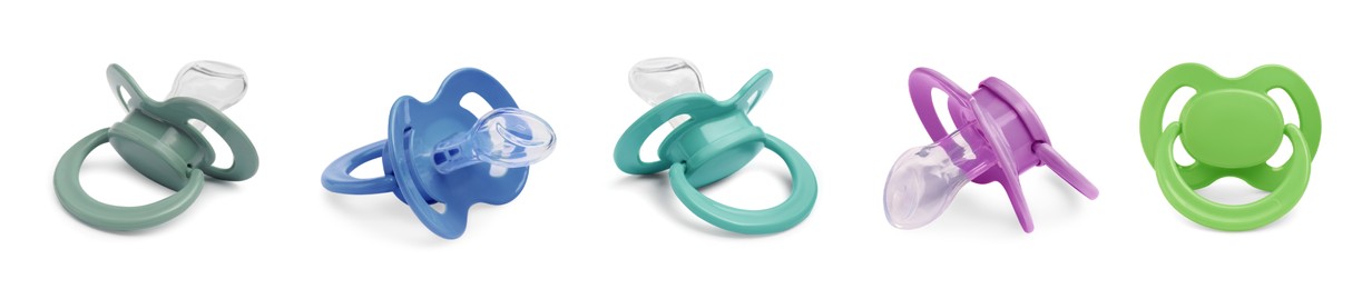 Image of Set of baby pacifiers in different colors on white background