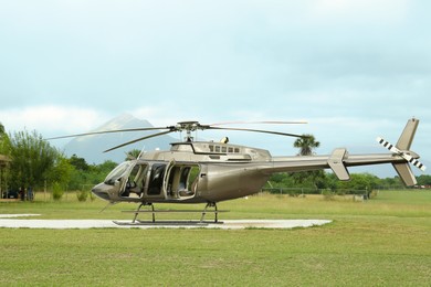 Beautiful modern helicopter on helipad in field