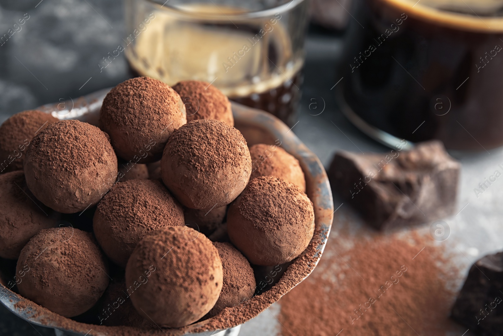 Photo of Bowl of tasty chocolate truffles on table, closeup with space for text