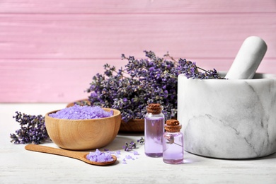 Photo of Composition with natural cosmetic products and lavender flowers on wooden table against pink background