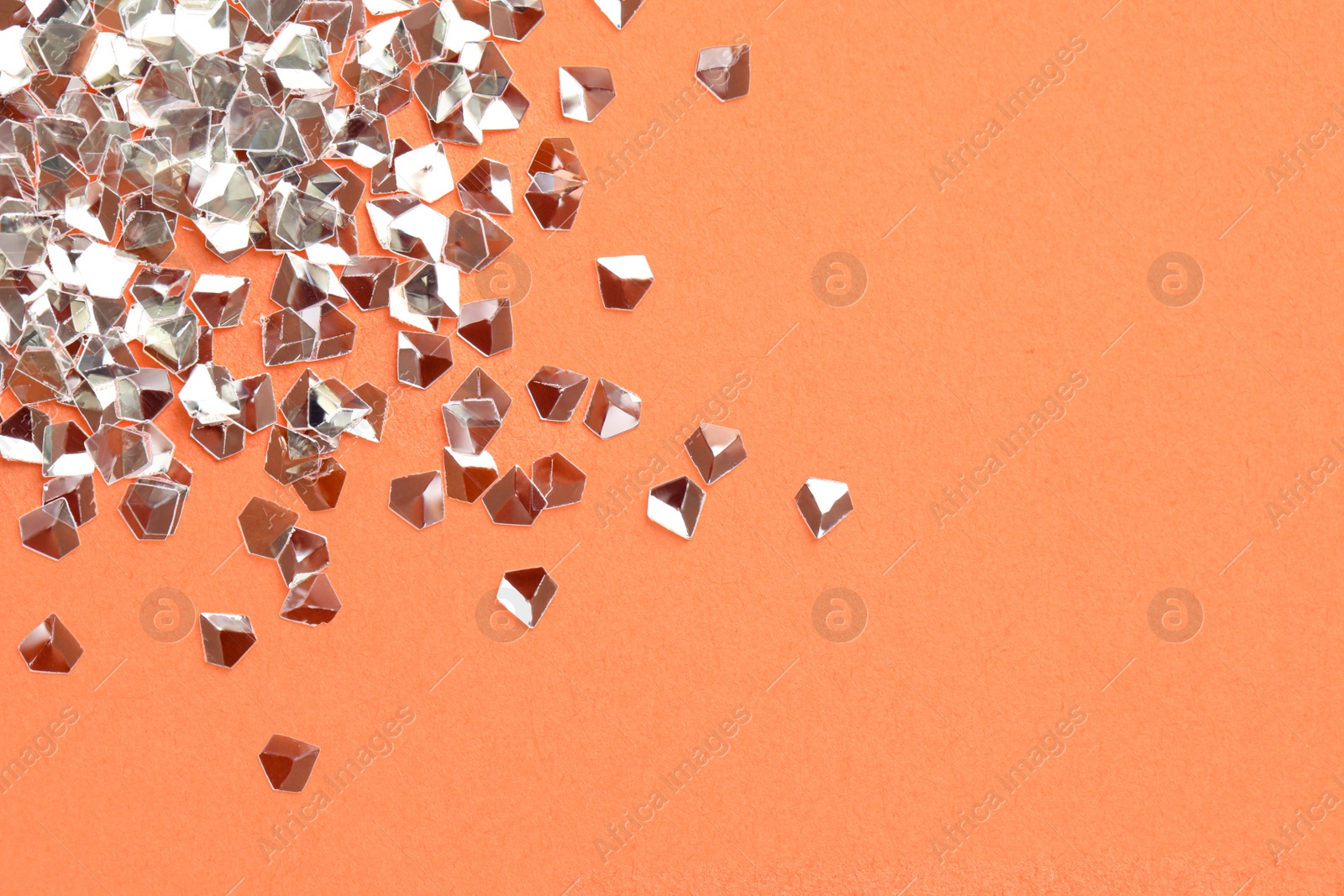 Photo of Pile of shiny glitter on pale pink background, flat lay. Space for text