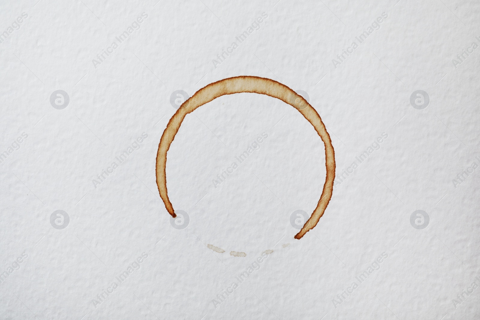 Photo of Dried coffee cup stain on white background, top view