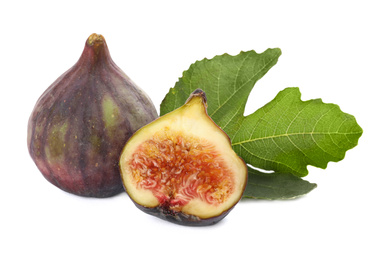 Photo of Tasty whole and cut figs with green leaf isolated on white