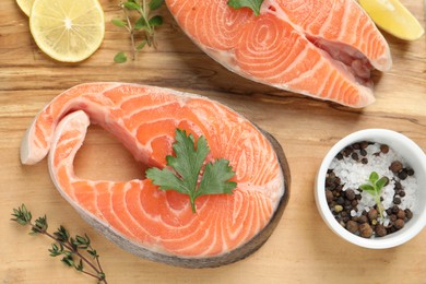 Fresh salmon and ingredients for marinade on wooden board, flat lay