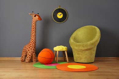 Child's room interior with comfortable armchair and toys