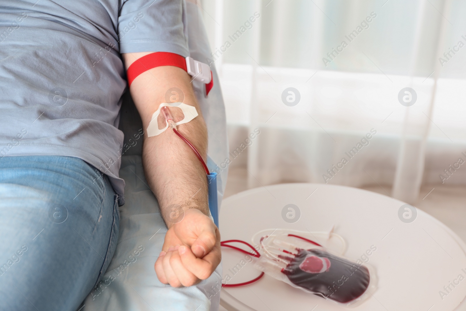 Photo of Man donating blood to save someone's life in hospital