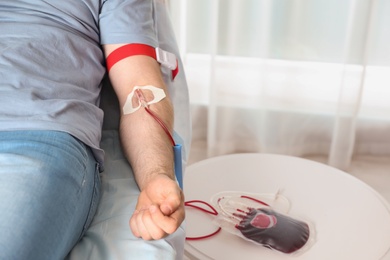 Man donating blood to save someone's life in hospital