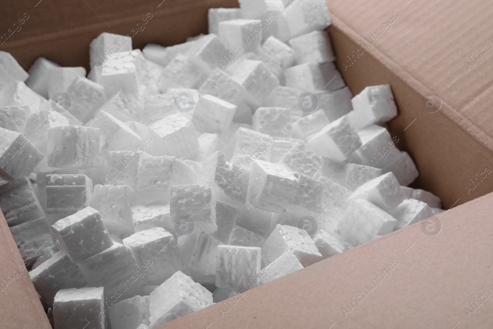 Photo of Closeup view of cardboard box with styrofoam cubes